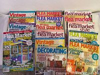 Several flea market and vintage style magazines stacked together, colorful covers with themes on gardens and DIY projects.