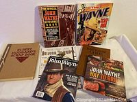 Photo of all items laid out showing covers of books and magazines in the lot