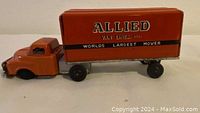 Front view of the orange Allied Van Lines toy truck showing logo.