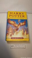 Front cover of Harry Potter and the Order of the Phoenix 2003 first Canadian edition hardcover book with title and phoenix artwork visible.