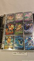 Binder page displaying nine Eeveelution Pokemon V cards in sleeves