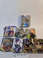 Overall view of the Waifu trading cards including a pile and visible layout of holographic cards.