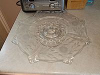 Top view of clear etched cornflower platter cake stand showing floral etching and scalloped edges