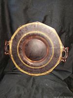 Top view showing full pink depression glass plater with octagonal shape, two handles and gold decoration along rim and handles.