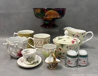 Photo of entire lot showing the Royal Stanley Jacobean Ware footed bowl and assorted ceramic cups, mugs, sugar bowl, creamer, basket, and salt and pepper shakers.