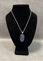 Front view of necklace displayed on black bust showing length and pendant details.