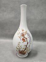 Front view of the vase showing detailed floral and bird artwork.