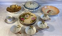 Overview of all items showing teacups, saucers, plates, large lidded bowl, and serving dish.