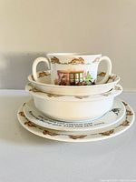 Stacked view of Bunnykins and Wedgwood Peter Rabbit dishes including cup, bowls, and plates