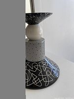 Side view of the candlestick showing the multi-patterned design and shape.