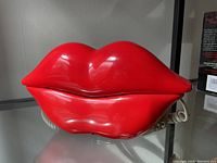 Front view of vintage phone shaped like red lips showing smooth glossy finish and sculpted shape.