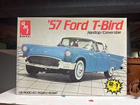 Box front of AMT Ertl 1957 Ford T-Bird plastic model kit 1:16 scale showing blue car image and details.