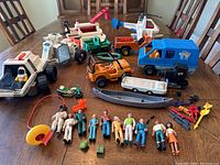 Image showing the full toy lot spread on a table, including vehicles, figures, and accessories.