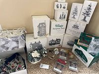 Stack of Dept 56 boxes including village buildings, evergreen tree sets, accessories