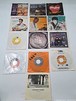 Photo of assorted vintage vinyl records and sleeves including Elvis Presley, Huey Lewis and others.