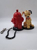 Front angle view of the full phone showing hydrant base and Dalmatian figure with handset connected