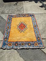 Full view of rug on concrete showing overall field and border