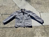 Full view of gray Harley Davidson motorcycle jacket laid flat showing front zipper, long sleeves, front flap pockets, and collar.