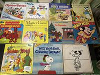 Full view of 11 assorted vintage LP record album covers featuring Disney characters, Chipmunks, Snoopy, Scooby-Doo, and more.