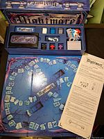 Nightmare board game open with board, various colored playing pieces, cards, two dice, and instruction sheet visible.