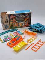 Overall view of pool components and original box showing condition and contents