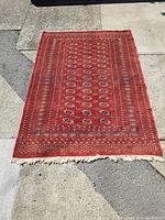 Full view of rug laid flat outdoors showing overall design and condition