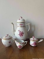 Front view of set including teapot, sugar bowl, creamer, and jam pot with lid and spoon