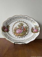 Oval Gloria Fine Porcelain Bayreuth plate with romantic period couple scene and gold accents on scalloped edges