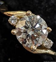 Front-closeup of ring showing center and side diamonds