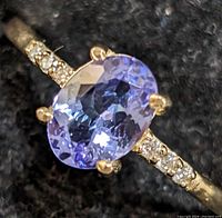 Top view close-up of oval tanzanite center stone and diamond-accented shank