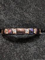 Close-up front view of sterling silver CZ eternity ring showing the rectangular blocks and cubic zirconia stones embedded in alternating pattern.