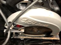 Close-up view of Skil circular saw blade and guard with logo and model number 5150 visible.