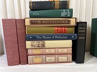 Front view of all stacked books, showing varied titles and cloth-bound covers