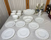Full collection showing milk glass dishes including plates, bowls, and decorative pieces.