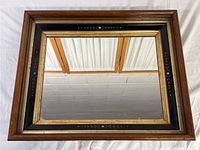 Full view of vintage rectangular mirror showing wooden frame with multiple layers and the reflective glass surface.