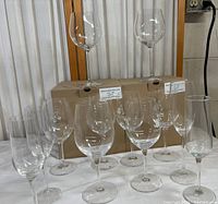Full view of all glasses arranged on table with two boxes behind.