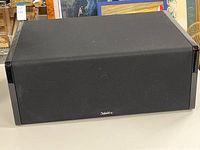 Front view of the Definitive Technology CLR-2000 center channel speaker showing fabric grille and logo.