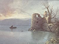 Close-up photo of the framed print showing the boat near a castle ruin in a lake at dusk.