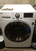 Front view of LG front-load washer/dryer showing Direct Drive badge, control knob and digital display