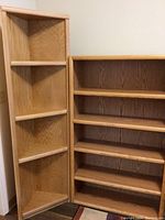 Image displaying full view of oak veneer tall bookcase beside the matching corner shelf, showing relative size and color match.