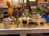 All items on workbench: cage, magnifier, two lamps, lens covers