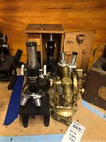 Photo showing Unitron MUS and Southern Precision brass microscopes with brass viewer in front.