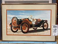 Framed poster showing a color image of a 1913 Baby Brewster vintage car with orange wheels and black body, set against a desert background.