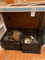 Two milk crate bins filled with assorted vintage bells