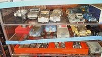 Top shelf row of seven Rolls Royce model cars in various colors