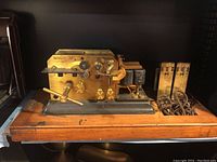 Full assembly of Omnigraph telegraph code device on wooden base with two brass coil modules to the right