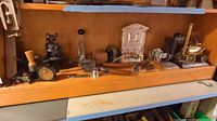 Wide view of shelf showing assorted tools, models, and parts