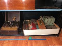 Overview of wooden bit set and white box containing banks, connectors and books