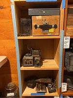 Shelf with wooden box, Beckman Resistance Test OHM Meter, mechanical parts and rusty tools