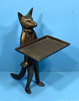 Brass fox business card holder angle view showing the profile of the standing fox figure and tray held in front.